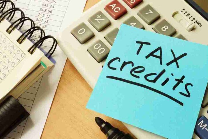 A calculator with a sticky note labeled 